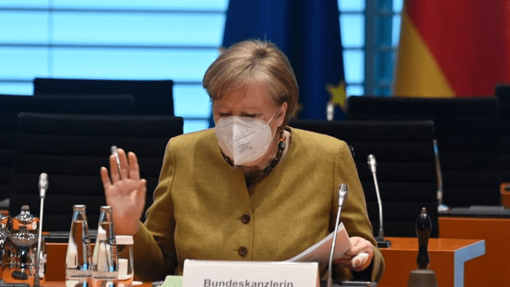 German Chancellor Angela Merkel gestures as she sits down for the weekly cabinet meeting on April 13, 2021 at the Chancellery in Berlin.