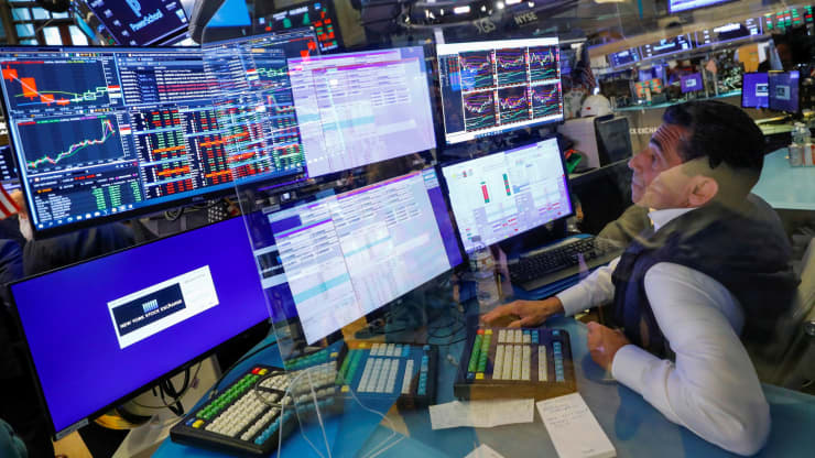 A trader works behind plexiglass on the floor of the New York Stock Exchange (NYSE) in New York City, New York, U.S., July 28, 2021.