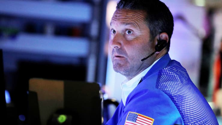 A trader works inside his post on the floor of the New York Stock Exchange (NYSE) in New York, July 21, 2021.