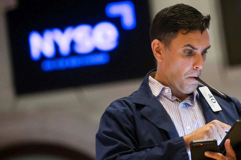 Traders work on the floor of the NYSE in New York