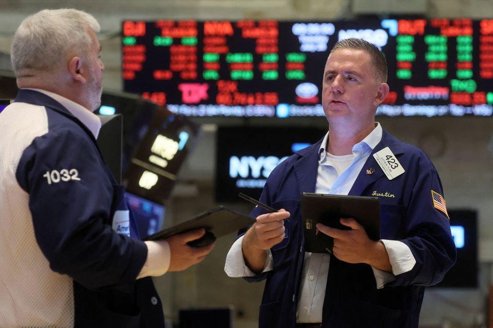 Traders work on the floor of the NYSE in New York