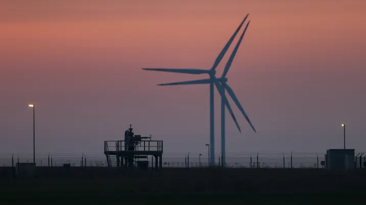 21 March 2022, Saxony-Anhalt, Bad Lauchstädt: Wind turbines rotate behind the surface facilities of a VNG AG underground gas storage facility. Here, the gas is stored in large cavities (caverns) in the salt dome or in porous rock. The discussion about a supply stop of Russian gas is not abating. Photo: Jan Woitas/dpa-Zentralbild/dpa (Photo by Jan Woitas/picture alliance via Getty Images)