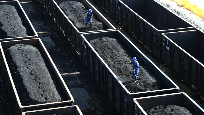 JIUJIANG, CHINA - AUGUST 19: Employees work on a freight train loaded with coal at Jiangxi Coal Reserve Center on August 19, 2022 in Jiujiang, Jiangxi Province of China. (Photo by VCG/VCG via Getty Images)