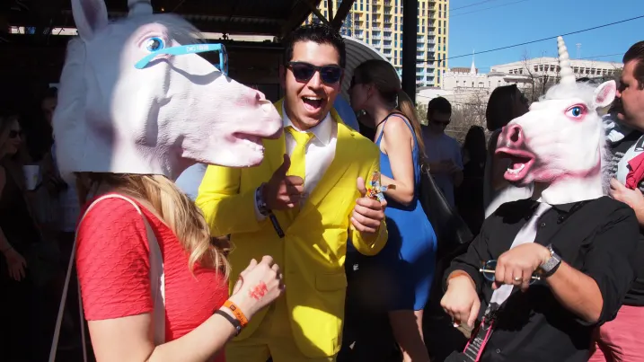 Partygoers with unicorn masks at the Hometown Hangover Cure party in Austin, Texas.