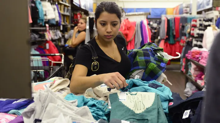 A shopper goes through shirts in the kids section at Old Navy in Denver, Colorado.