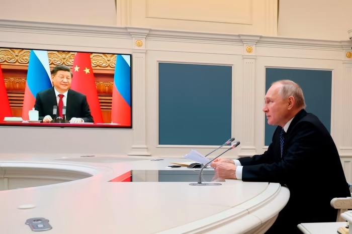 Vladimir Putin and Xi Jinping speak via video link in December. Several Chinese officials have in private striven to distance Beijing from  Moscow on the issue of Ukraine